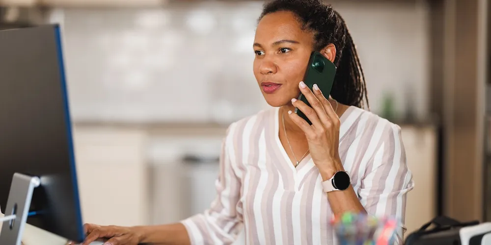 A senior living sales specialist speaking with a prospective resident by phone